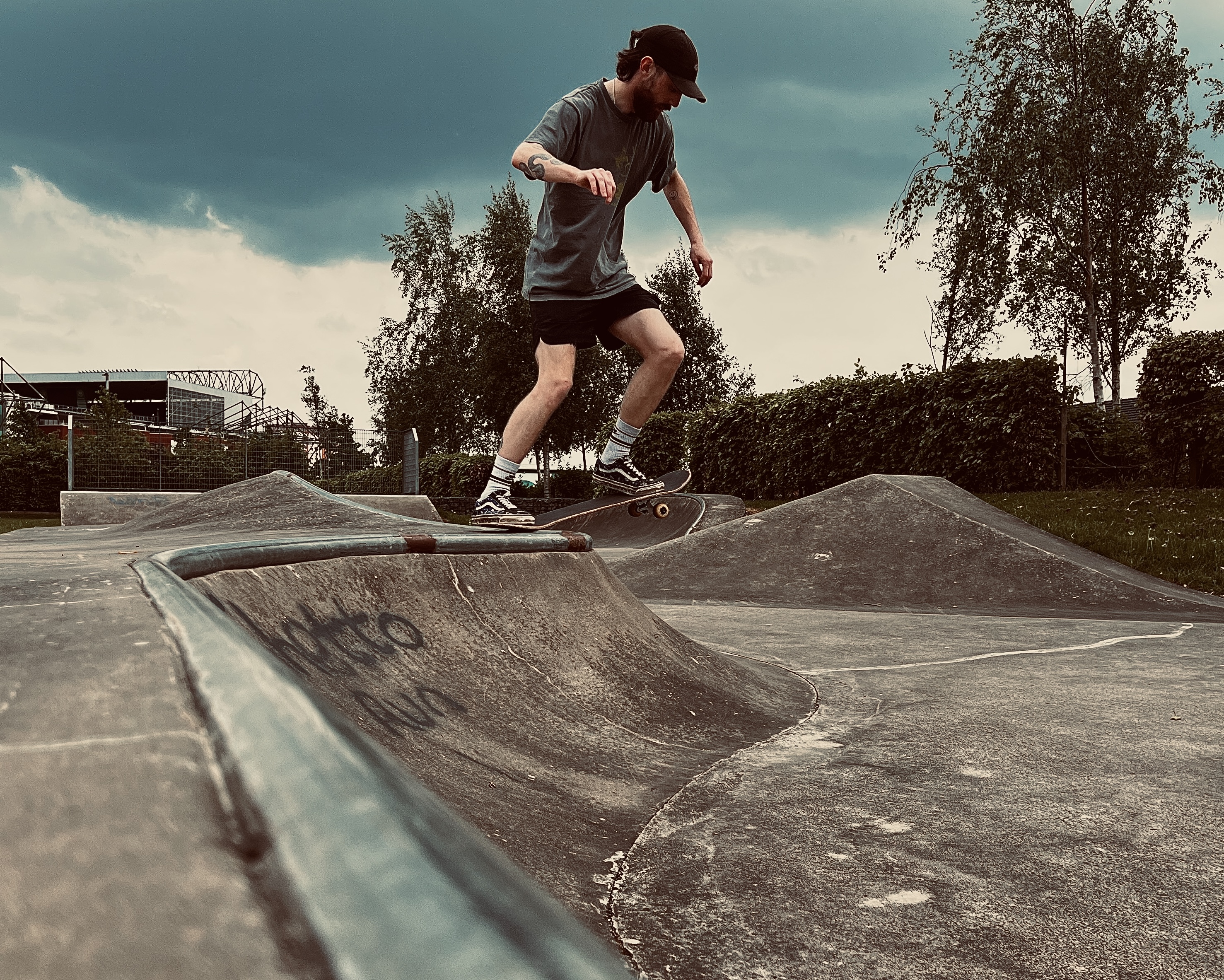 skateboarder about to drop in on small quarter pipe