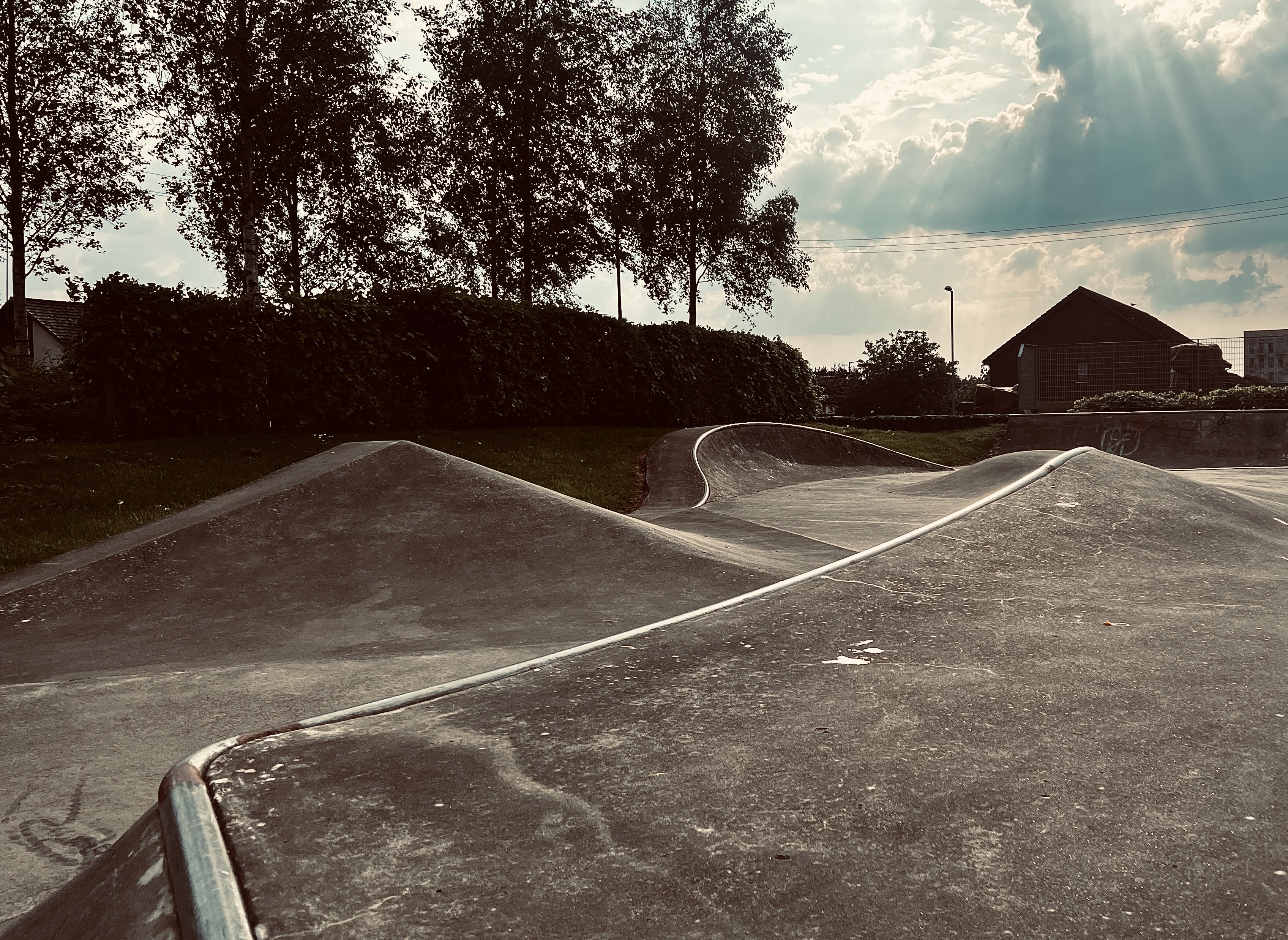 long view down park with obstacles and quarter pipe at end.